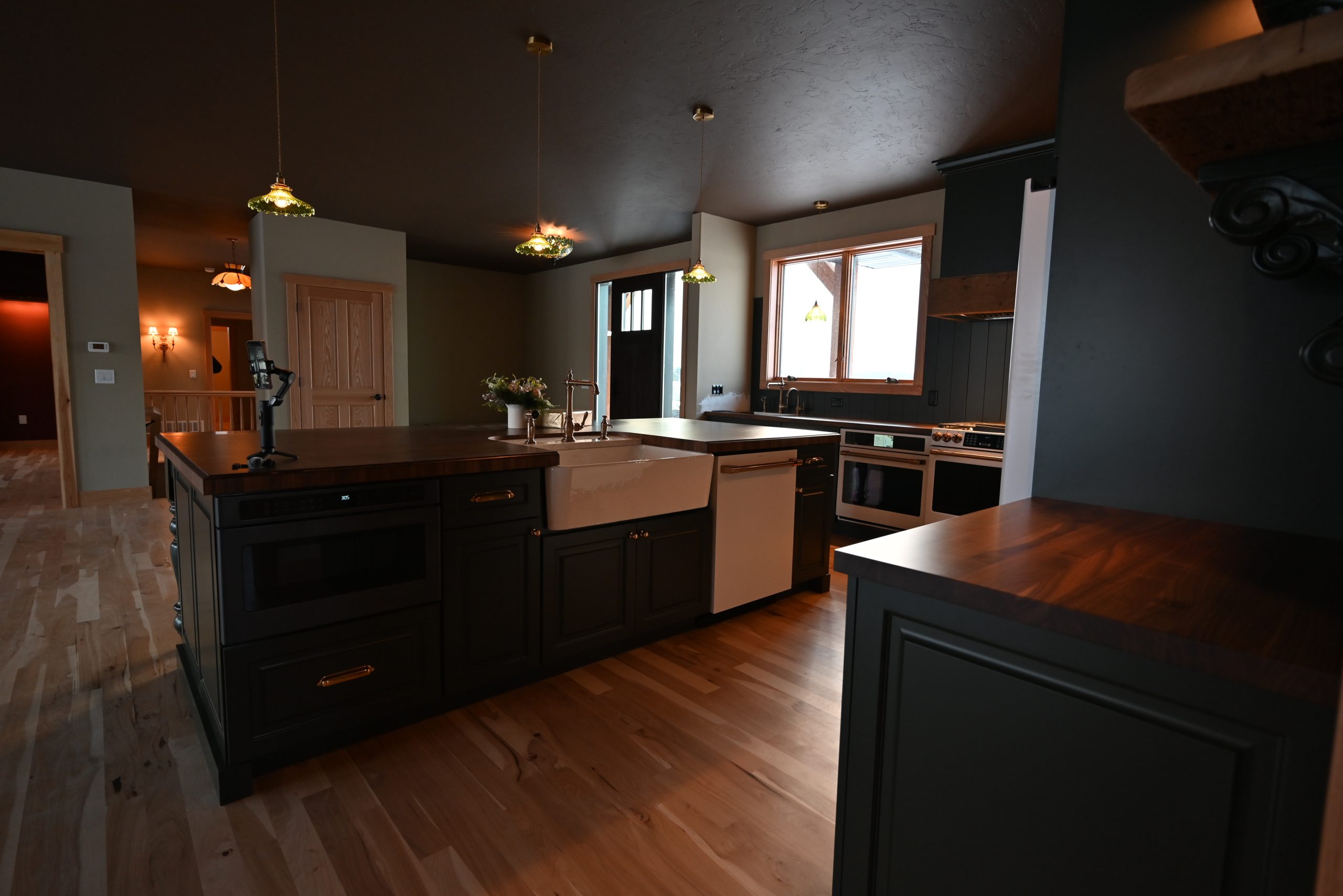 Custom kitchen with dark cabinetry and island by Bartow Builders
